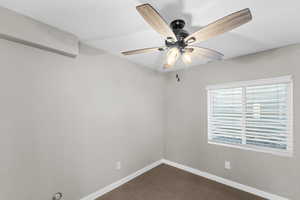 Basement bedroom featuring a ceiling fan