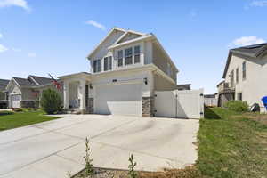 Craftsman-style house with a garage and a front lawn