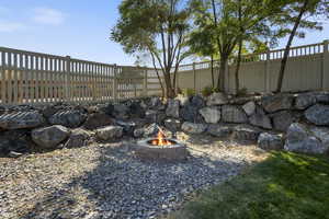 View of yard with an outdoor fire pit