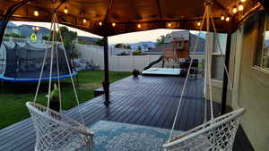 View of patio / terrace with a wooden deck and a trampoline