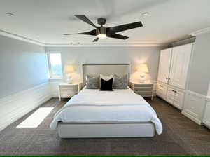 Primary bedroom with crown molding and ceiling fan