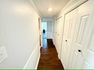 Hallway has extra storage closets. Door on left is half bathroom. Door at end is Bedroom 3.