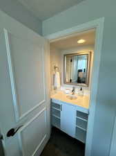 Vanity with sink located inside closet of third bedroom.