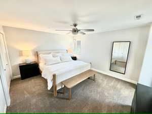 Second bedroom featuring carpet flooring and ceiling fan