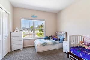 Bedroom featuring a closet and carpet flooring