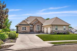 View of front of house featuring a garage and a front lawn