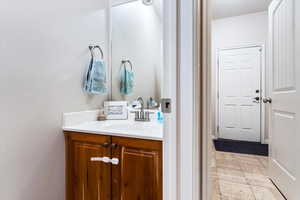 Bathroom featuring tile patterned flooring and vanity