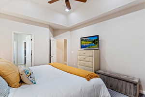 Bedroom featuring ensuite bathroom and ceiling fan