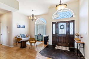 Entrance foyer featuring a notable chandelier and hardwood / wood-style flooring