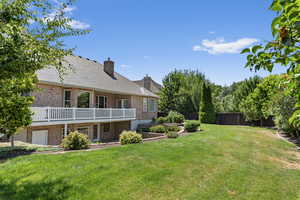 View of yard featuring a balcony