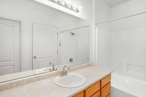 Bathroom featuring bathing tub / shower combination and vanity