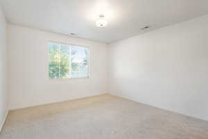 Spare room featuring carpet flooring