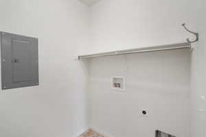 Washroom featuring electric panel, hookup for an electric dryer, and washer hookup