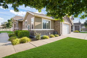 View of front of house featuring a garage and a front lawn