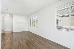 Unfurnished room with dark wood-type flooring