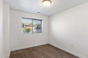 Unfurnished room with carpet flooring