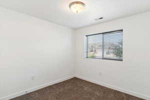 Empty room with carpet flooring