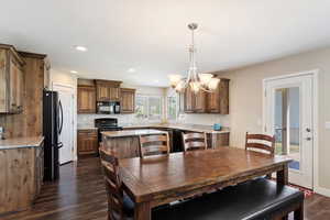 Dining area featuring dark hardwood / wood-style flooring and an inviting chandelier