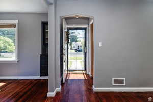 Doorway featuring dark hardwood / wood-style floors and plenty of natural light