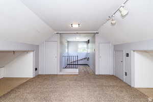 Bonus room featuring lofted ceiling and light colored carpet