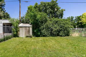 View of yard featuring a storage unit