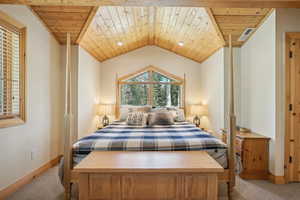 Carpeted bedroom with vaulted ceiling and wood ceiling