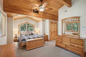 Carpeted bedroom with vaulted ceiling with beams, wood ceiling, and ceiling fan