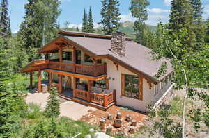 Back of house featuring a patio and a balcony