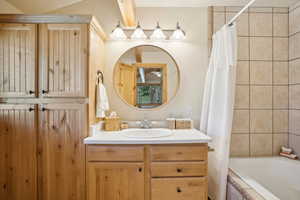 Bathroom with vanity and shower / tub combo with curtain