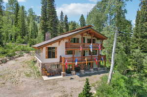 Rear view of house featuring a balcony and a patio