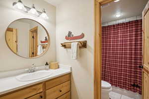 Bathroom with vanity, toilet, and tile patterned flooring