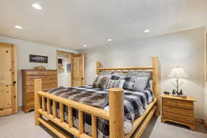 Bedroom featuring light colored carpet