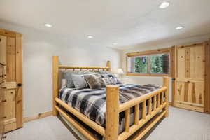 Bedroom featuring light colored carpet