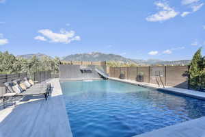 View of swimming pool featuring a mountain view and a water slide