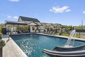 View of swimming pool with pool water feature and a patio