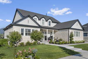 View of front of property featuring a porch and a front lawn