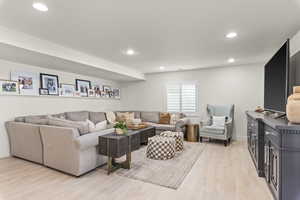 Living room with light hardwood / wood-style floors