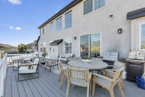 Deck with a grill and an outdoor hangout area