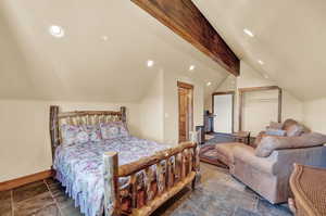 Tiled bedroom with vaulted ceiling with beams