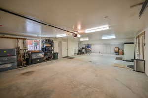 Garage with white fridge and a garage door opener