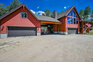 View of front of property featuring a carport and a garage