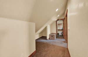 Bonus room featuring carpet and lofted ceiling