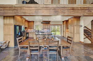 Tiled dining room with a high ceiling