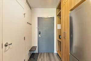 Doorway to outside with wood-type flooring