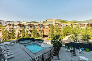 View of swimming pool featuring a patio and a community hot tub