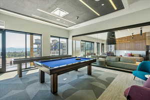 Game room featuring a mountain view, carpet flooring, a healthy amount of sunlight, and pool table