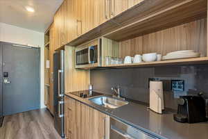 Kitchen featuring sink, dark hardwood / wood-style floors, and stainless steel appliances