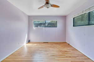 bedroom featuring a wealth of natural light, light wood-type flooring, and ceiling fan