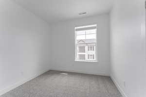 Unfurnished room with carpet