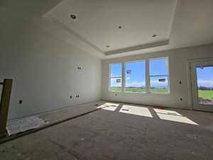 Unfurnished room with a raised ceiling